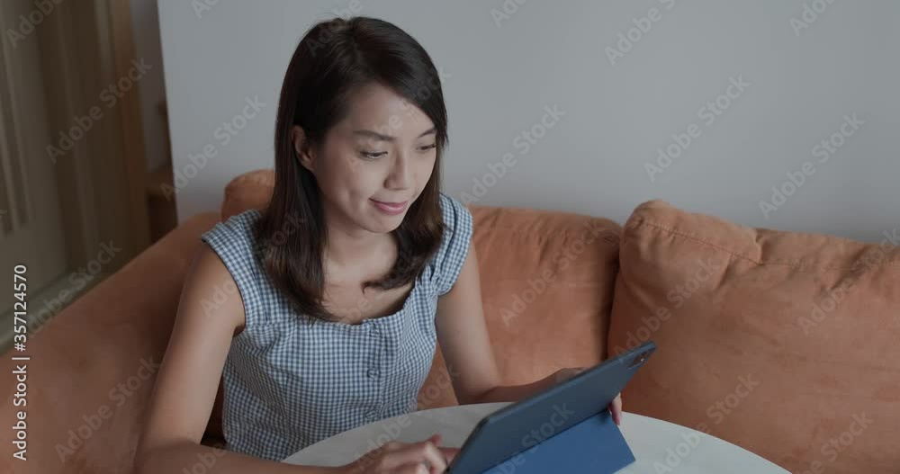 Woman read on tablet computer at home