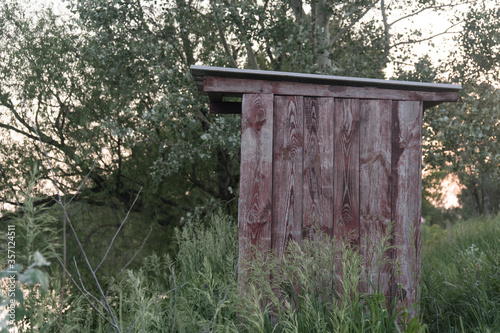 Wooden toilet in a Russian village in the summer