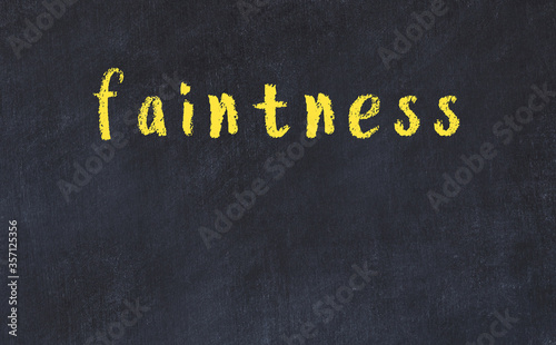 College chalk desk with the word faintness written on in