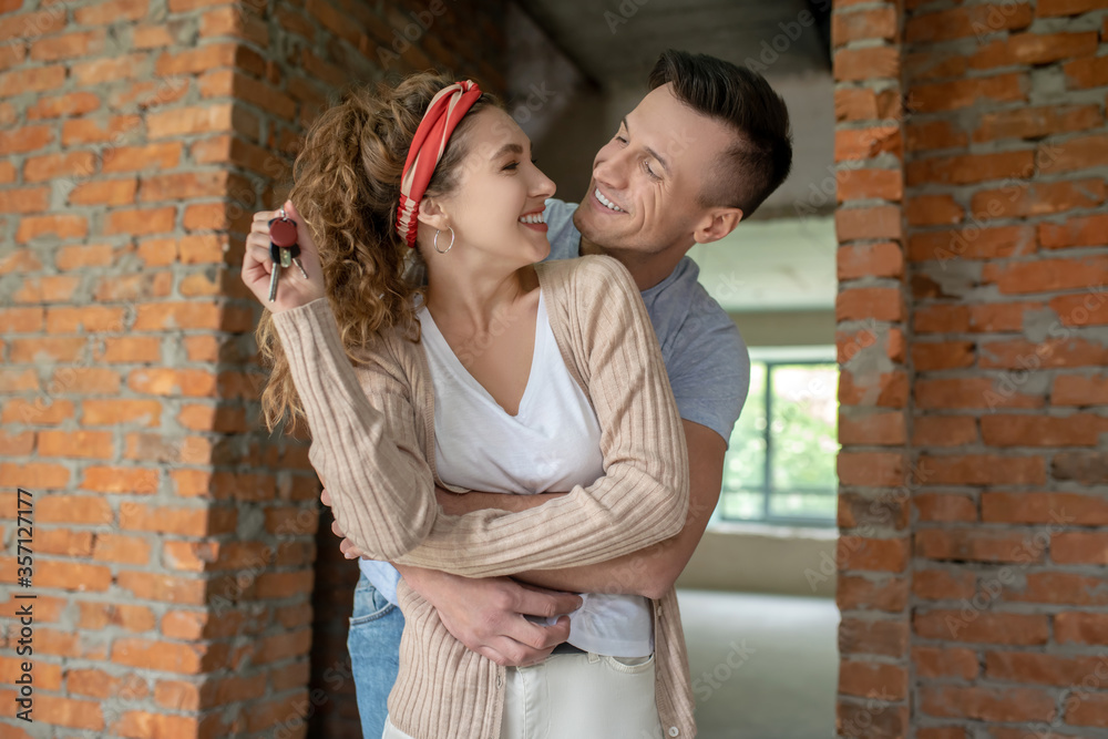 Young couple feeling happy and excited after buying a flat in a new house Young couple feeling happy and excited after buying a flat in a new house