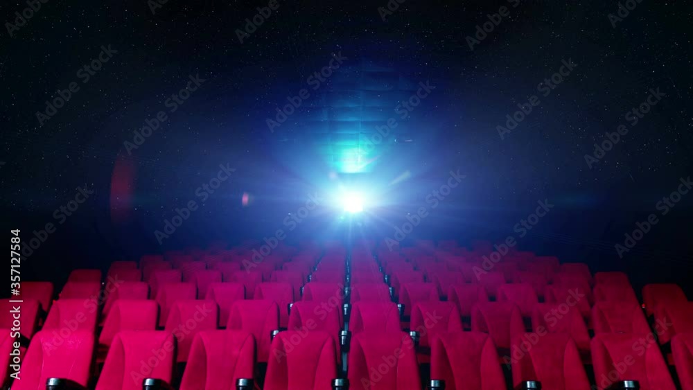 cinema public seats with lights from film projector on background