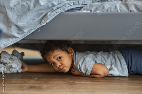 Tableau sur toile Family at home concept, boy playing hide and seek