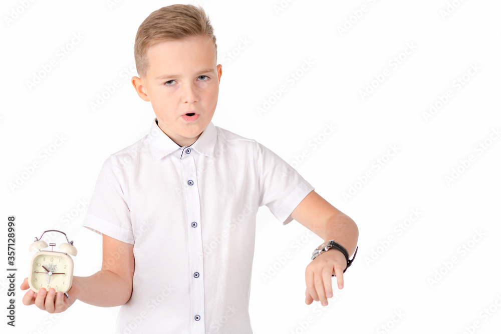 Surprised schoolboy with alarm clock and wach, isolated on white Surprised schoolboy with alarm clock and wach, isolated on white