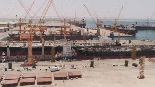 Aerial view of a shipyard in Oman. Oman Drydock Company (ODC) is one of the largest and most modern ship repair yards throughout the world. photo