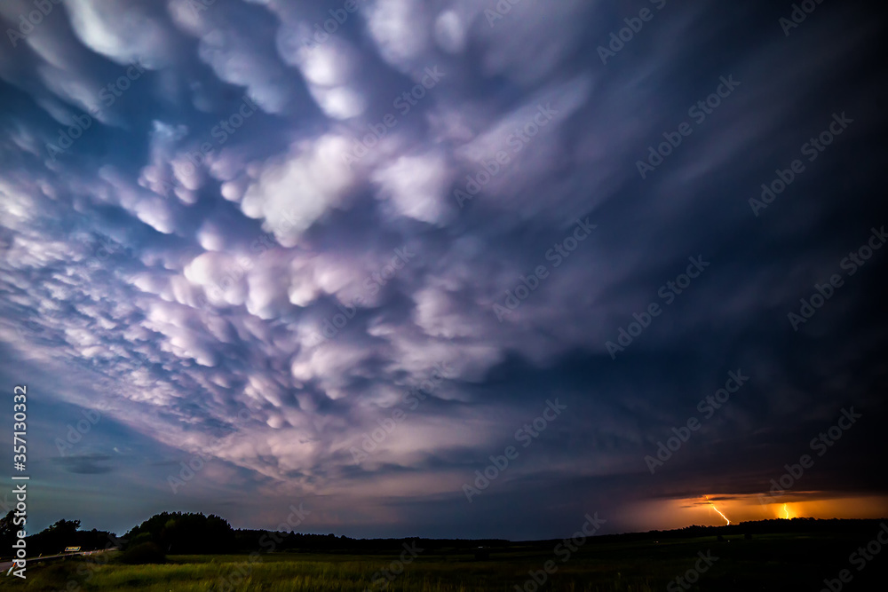 Late evening mammatus clouds with lightning