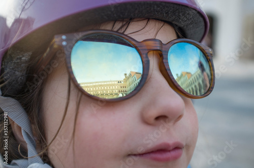 Little girl wearing mirror sunglasses at Upper Square of Badajoz
