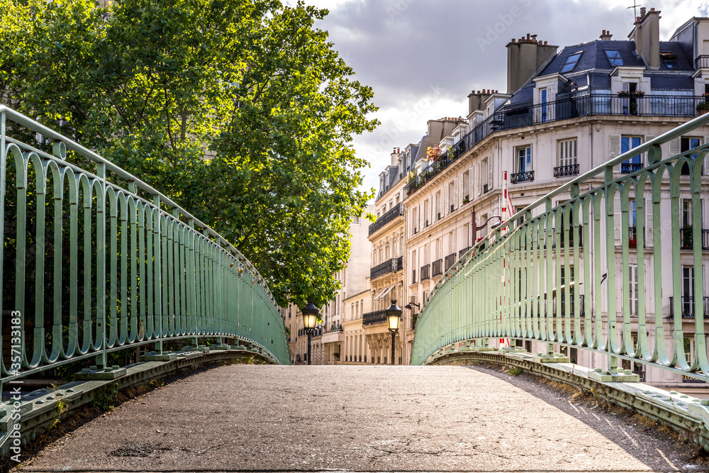 Paris, France - May 25, 2020: Iconic bridge of the Canal Saint-Martin in Paris France, a popular destination for Parisians, tourists and students on a beautiful Spring day