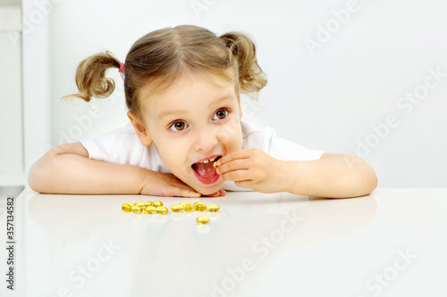the child is happy to try to eat omega 3 fish oil photo