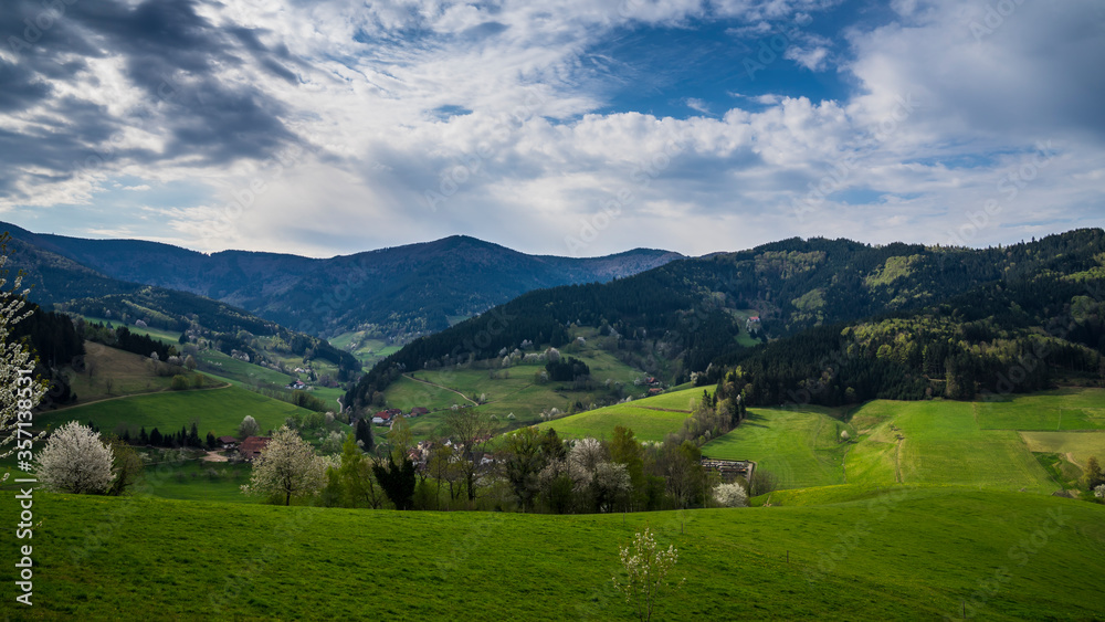 Germany, Paradise like green natural forested mountains of black forest nature landscape trees with moving clouds at small village
