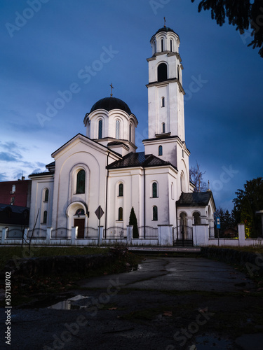 Religious building, Orthodox church dedicated to the Protection of the Holy Virgin with ominous, dark storm clouds in the background. Brod, Bosnia and Herzegovina.