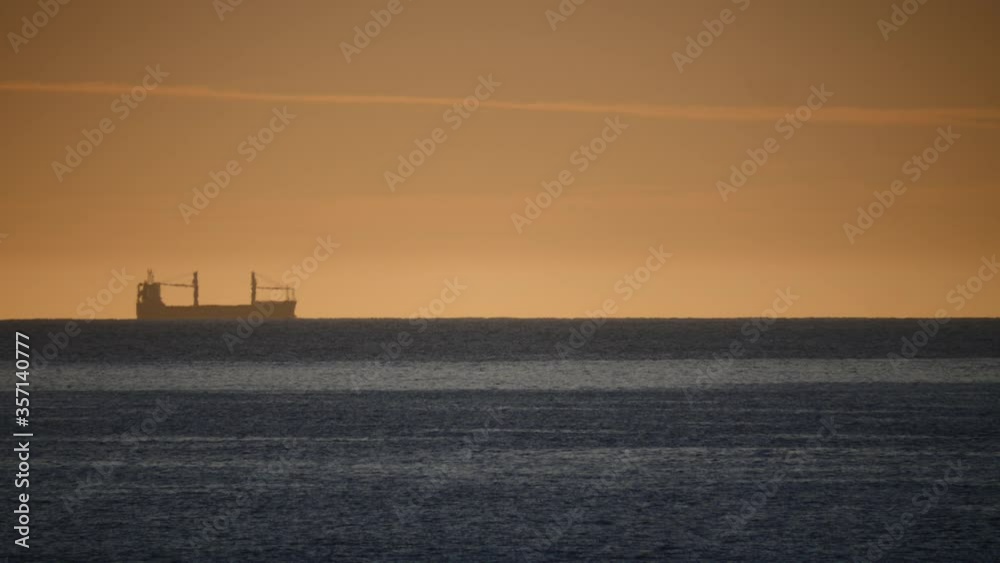 Seascape at morning with cargo container industrial ship on horizon. Logistic shipping concept