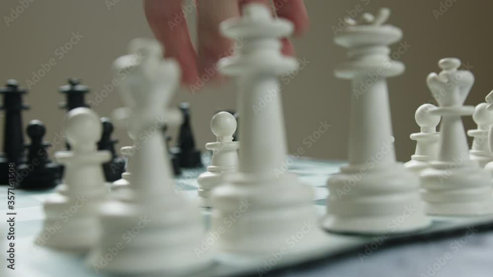 Black and white chess pieces on the chess board close-up Black and white chess pieces on the chess board close-up
