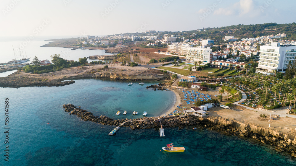 Aerial bird's eye view of Green bay Protaras, Paralimni, Famagusta, Cyprus. Famous tourist attraction diving location rock beach with boats, sea restaurant, water sports on summer holidays, from above
