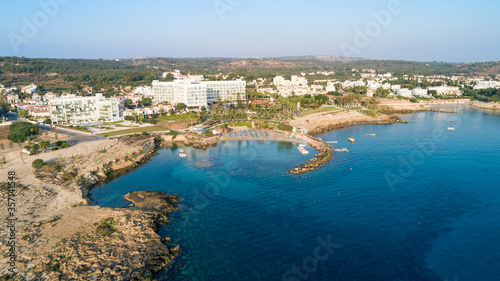 Aerial bird's eye view of Green bay in Protaras, Paralimni, Famagusta, Cyprus. Famous tourist attraction diving location rocky beach with boats, sunbeds, sea restaurants, water sports from above. © f8grapher