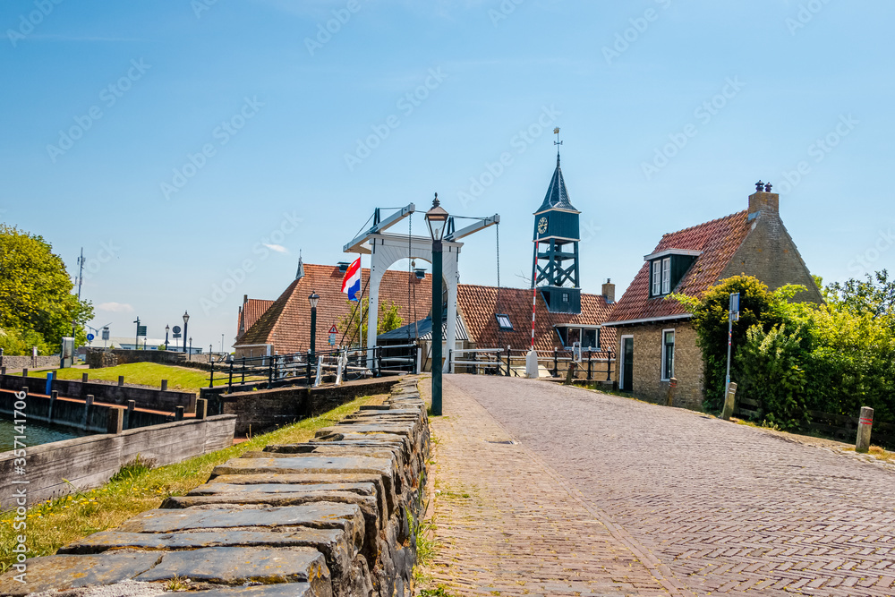 Hindeloopen a beautiful town in the Netherlands on the IJsselmeer, province of Friesland with canal boats and a harbor Hindeloopen a beautiful town in the Netherlands on the IJsselmeer, province of Friesland with canal boats and a harbor