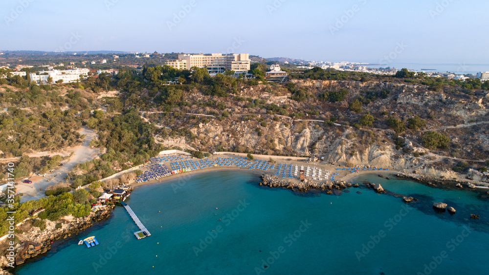 Aerial bird's eye view of Konnos beach in Cavo Greco Protaras, Paralimni, Famagusta, Cyprus. The famous tourist attraction golden sandy Konos bay, yachts, on summer holidays, at sunrise from above