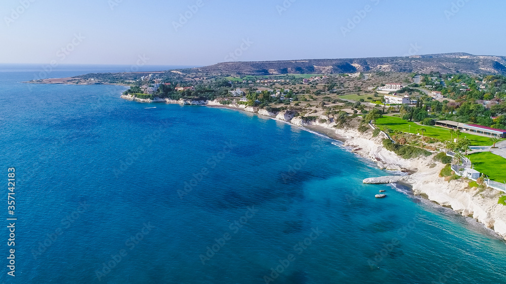 Aerial view of coastline and landmark big white chalk rock at Governor's beach,Limassol, Cyprus. Steep stone cliffs and deep blue sea waves next to Kalymnos fish restaurant and vasilikos power station