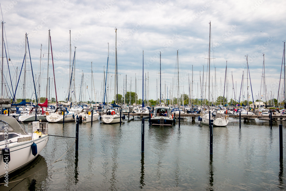 Harbor full of pleasure yachts and sailing boats in the village of Makkum in the Netherlands, province of Friesland