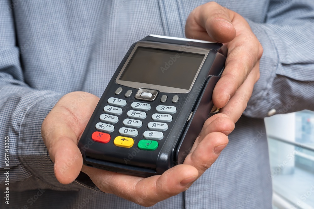 Payment terminal in hand of man Payment terminal in hand of man