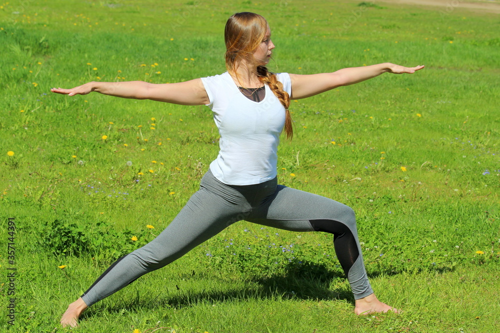 Young woman of European appearance does yoga in summer nature Young woman of European appearance does yoga in summer nature