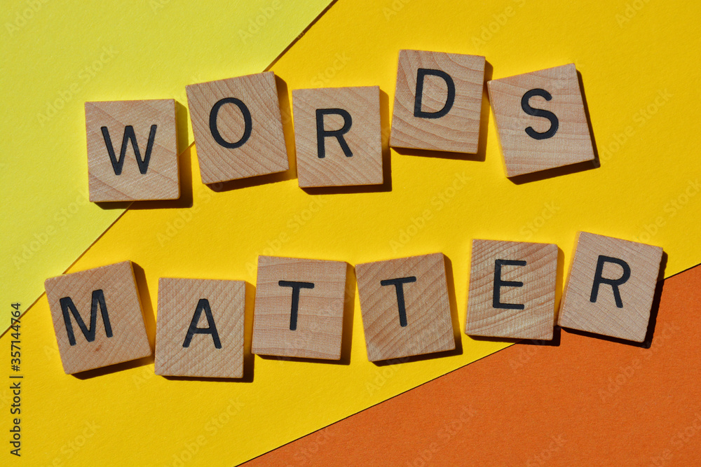 Words Matter, in wooden alphabet letters isolated on bright yellow and orange background