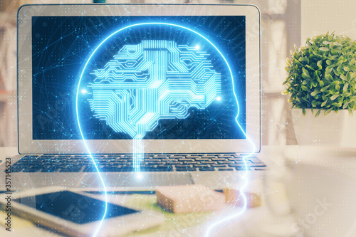 Double exposure of work space with computer and human brain drawing hologram. Brainstorm concept.