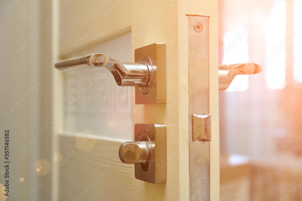 Modern style doorknob on a wooden door. Door lock Modern style doorknob on a wooden door. Door lock