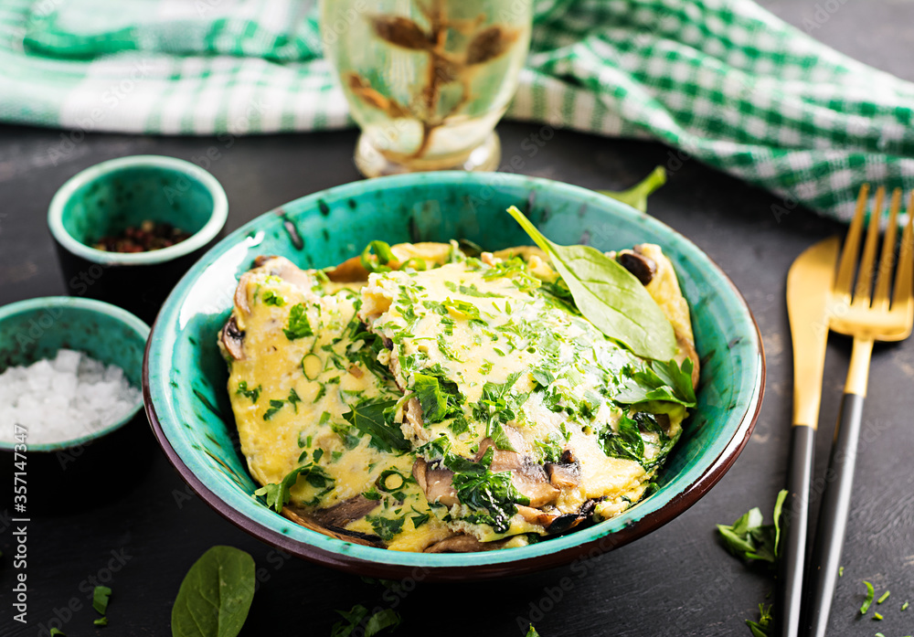 Spinach and mushroom omelette. Frittata made of eggs, mushrooms and spinach. Italian cuisine. Spinach and mushroom omelette. Frittata made of eggs, mushrooms and spinach. Italian cuisine.
