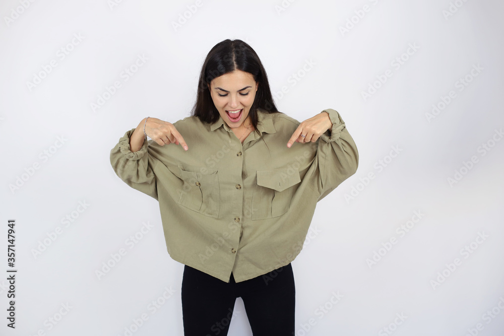 Young beautiful woman standing over white isolated background smiling and pointing down Young beautiful woman standing over white isolated background smiling and pointing down