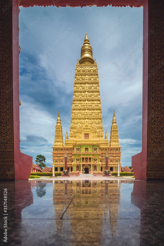 Fototapeta premium The scenery of the reflection of the Wat Bang Thong temple (golden pagoda) at Krabi province, Thailand.
