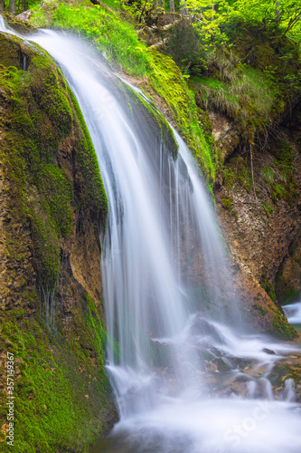 Little waterfall with rocks and green moss near Gunzesried. Allgäu, Bavaria, Germany