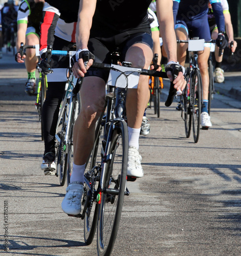 legs of cyclists pedaling during the road cycling race