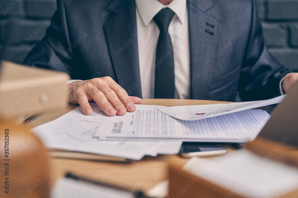 Fototapeta premium Focused photo on male hands that holding documents