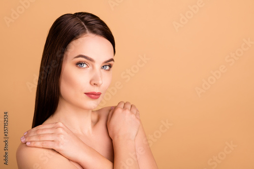 Close up photo of gorgeous lady hug her body after shower spa salon therapy to make skin pure silky smooth isolated over beige color background