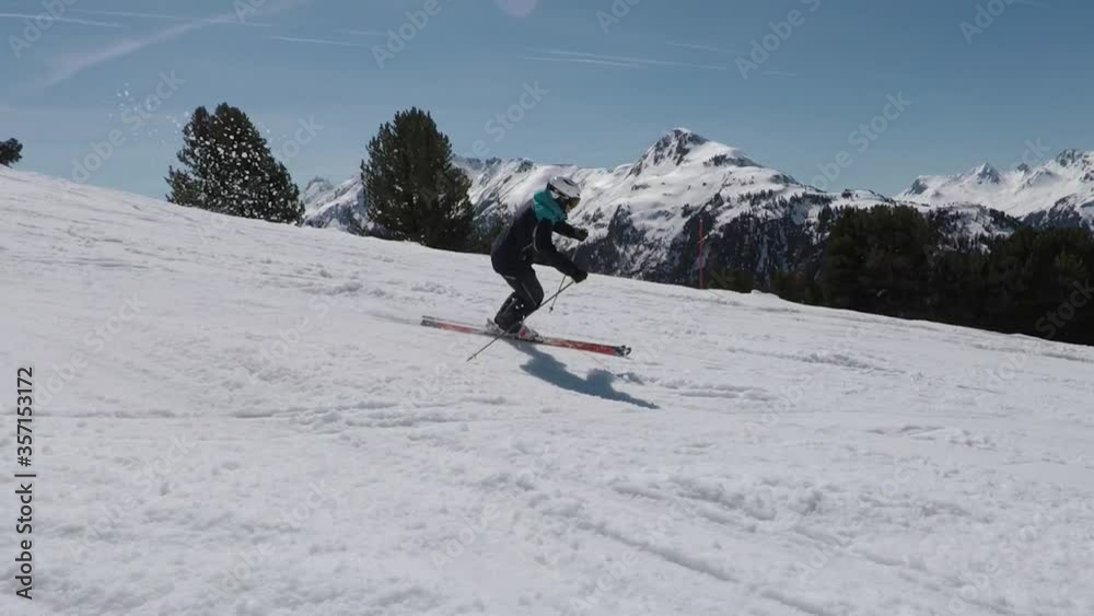 Slomotion skiing with professional athlete in perfect mountain panorama. Slomotion skiing with professional athlete in perfect mountain panorama.
