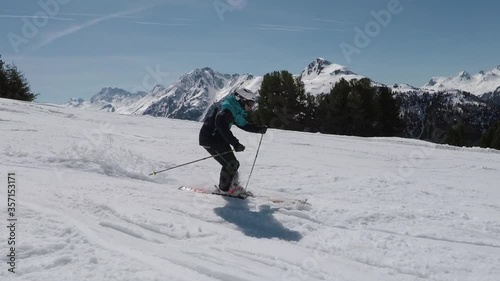 Professional skier is showing awesome ski turns on point. Super steady filming with the best mountain view in the alps. Sixty pitucers photo