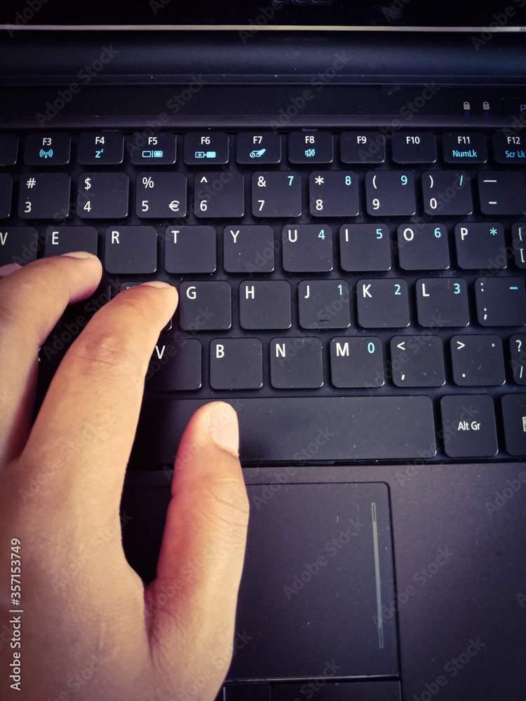 Typing hands on laptop keyboard