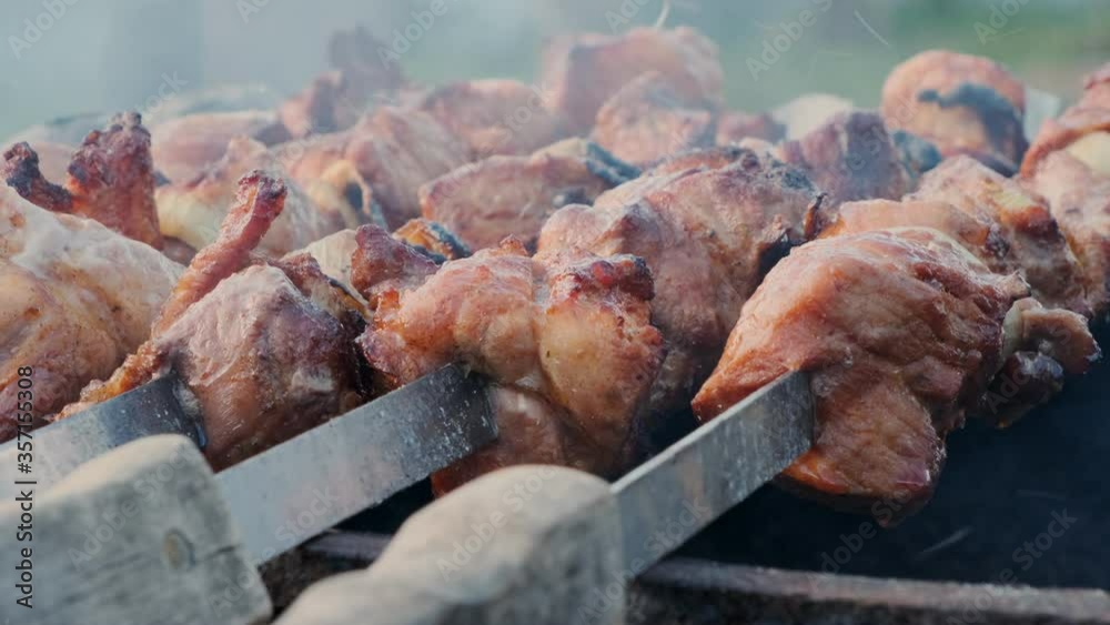 Shish kebab on charcoal in barbecue close-up outdoors.