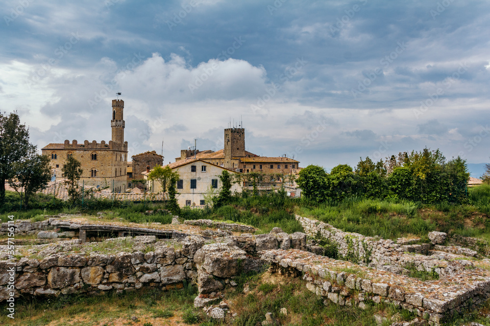 The Etruscan Acropolis on the background of a medieval city in the archaeological park of Volterra.