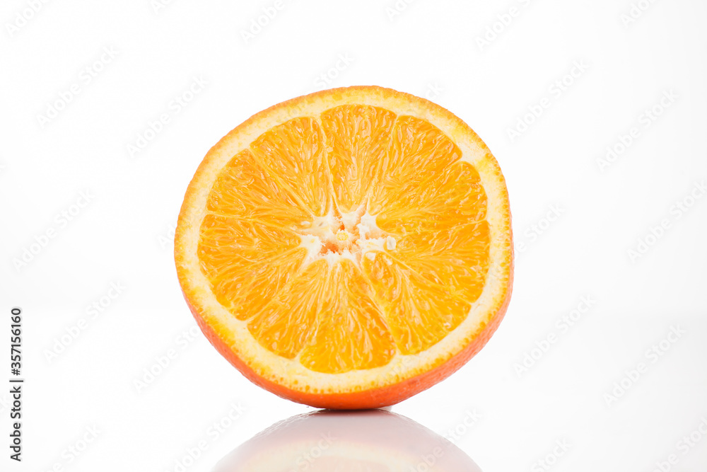 Sliced orange on a white background with reflection at the bottom. Isolated photo of citrus. Sliced orange on a white background with reflection at the bottom. Isolated photo of citrus.