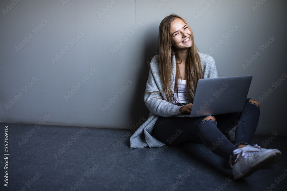 Pretty, young woman with her laptop studying for an exam/working Pretty, young woman with her laptop studying for an exam/working