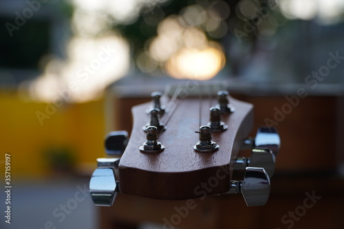 Shot of the head stock of an acoustic guitar,Natural Bokeh Light Background