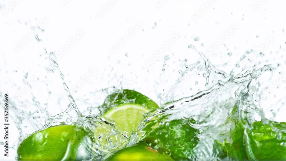 Fresh Limes Slices Falling with Water Splash in Super Slow Motion. Shot at 1000 fps Fresh Limes Slices Falling with Water Splash in Super Slow Motion. Shot at 1000 fps