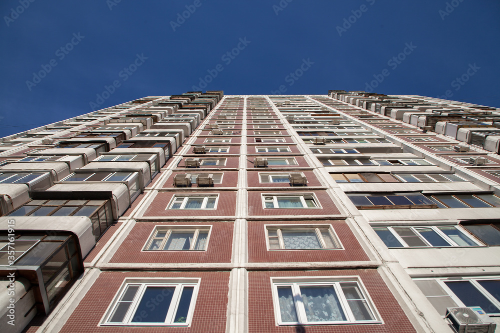 Residential building in the style of architecture of the USSR, facade and windows of a residential building Residential building in the style of architecture of the USSR, facade and windows of a residential building