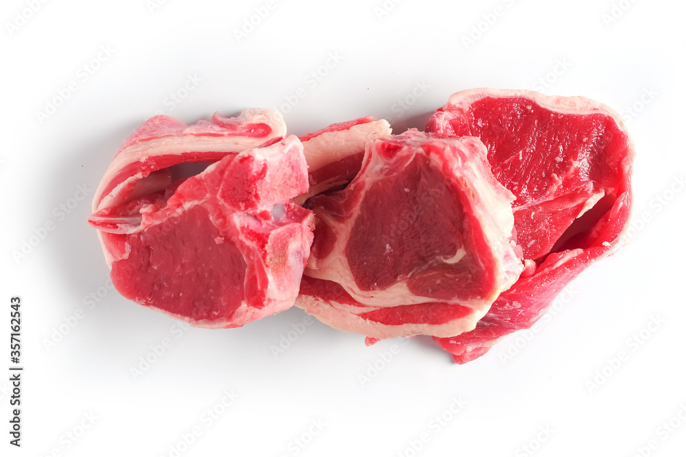 Fototapeta premium Three fresh raw lamb loin chops on a white background, isolated. Meat industry.