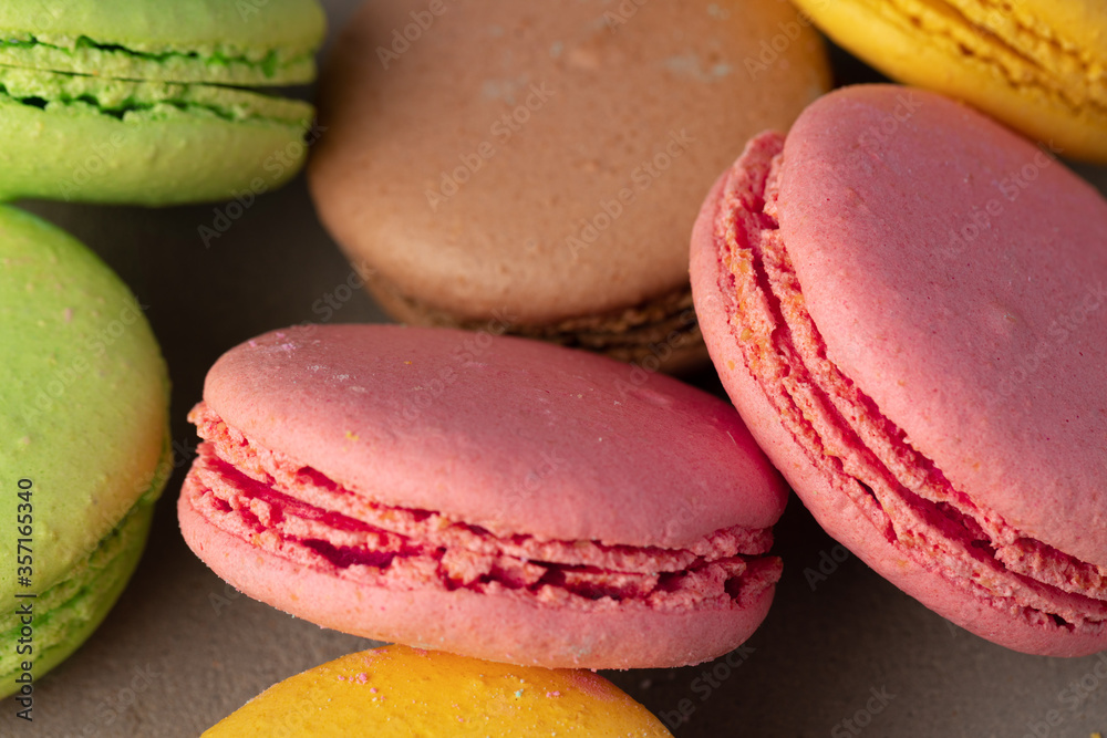 Colorful macaroon cookies on grey surface close up Colorful macaroon cookies on grey surface close up