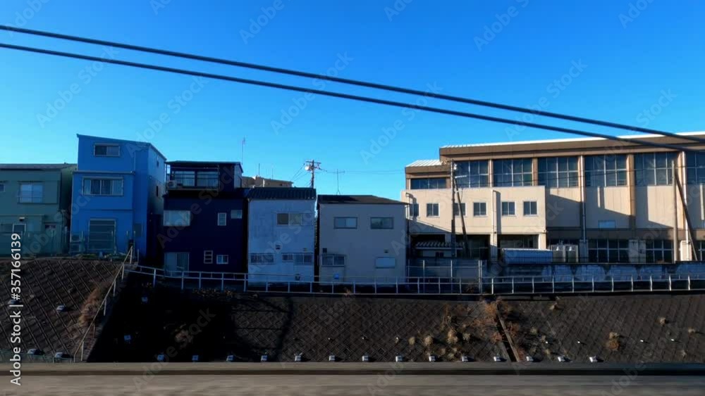 4K, Cityscape view througth window from train travels in city during a beautiful day with blue sky. Trains departing from a railway station. Japanese street with house building. Travel concept.-Dan 4K, Cityscape view througth window from train travels in city during a beautiful day with blue sky. Trains departing from a railway station. Japanese street with house building. Travel concept.-Dan