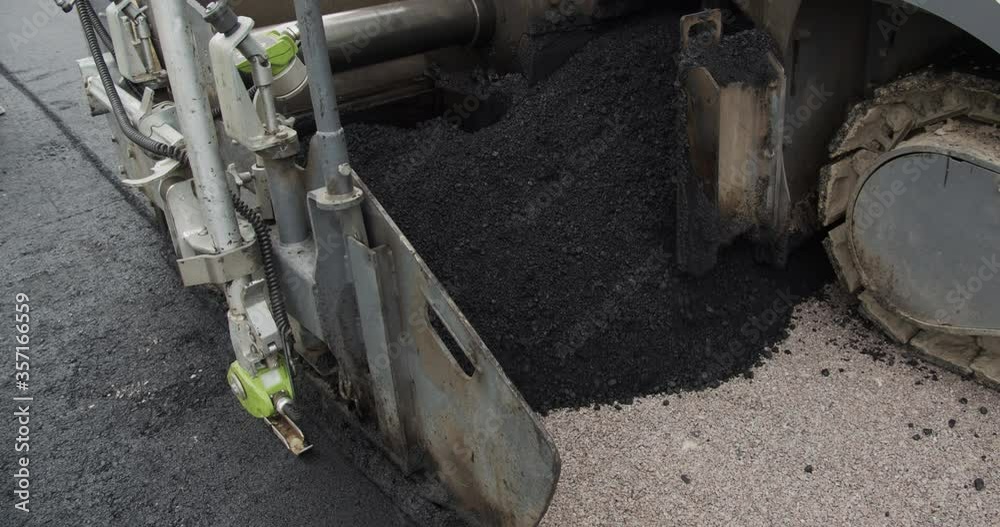 Asphalt Paver Applying Asphalt On The Highway. Asphalt Paver Applying Asphalt On The Highway.