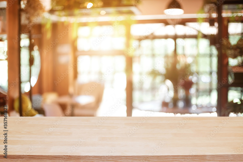 Empty wooden table space platform and blurred restaurant or coffee shop background for product display montage. Empty wooden table space platform and blurred restaurant or coffee shop background for product display montage.