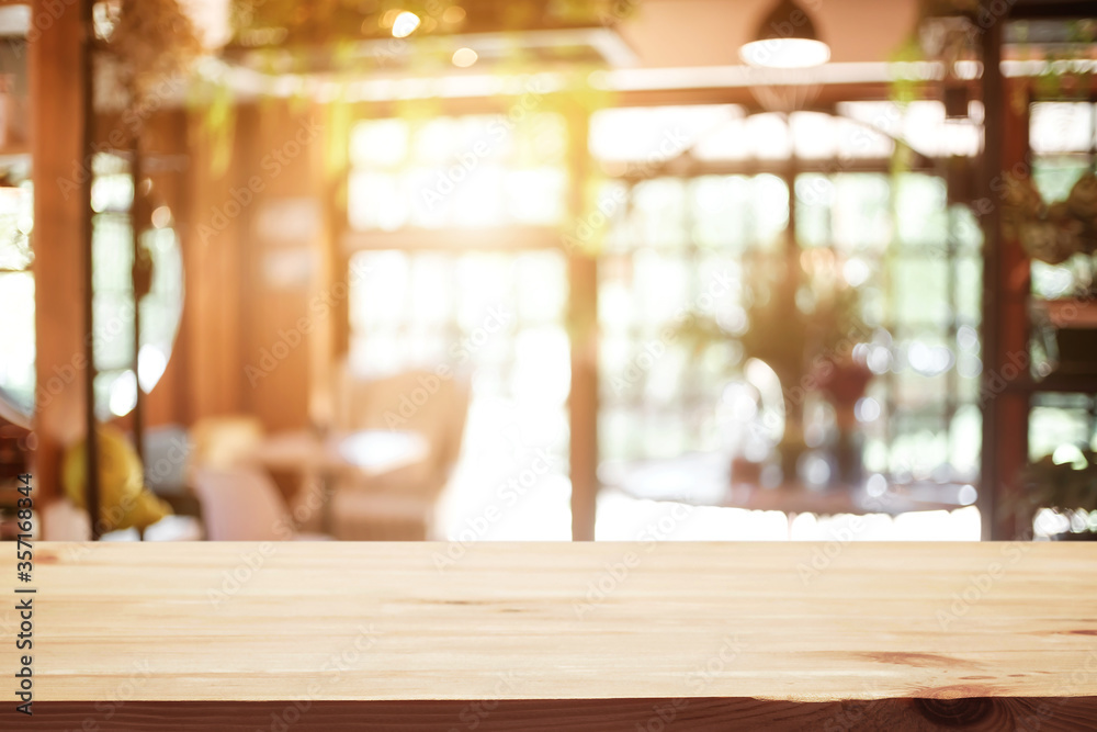 Empty wooden table space platform and blurred restaurant or coffee shop background for product display montage. Empty wooden table space platform and blurred restaurant or coffee shop background for product display montage.